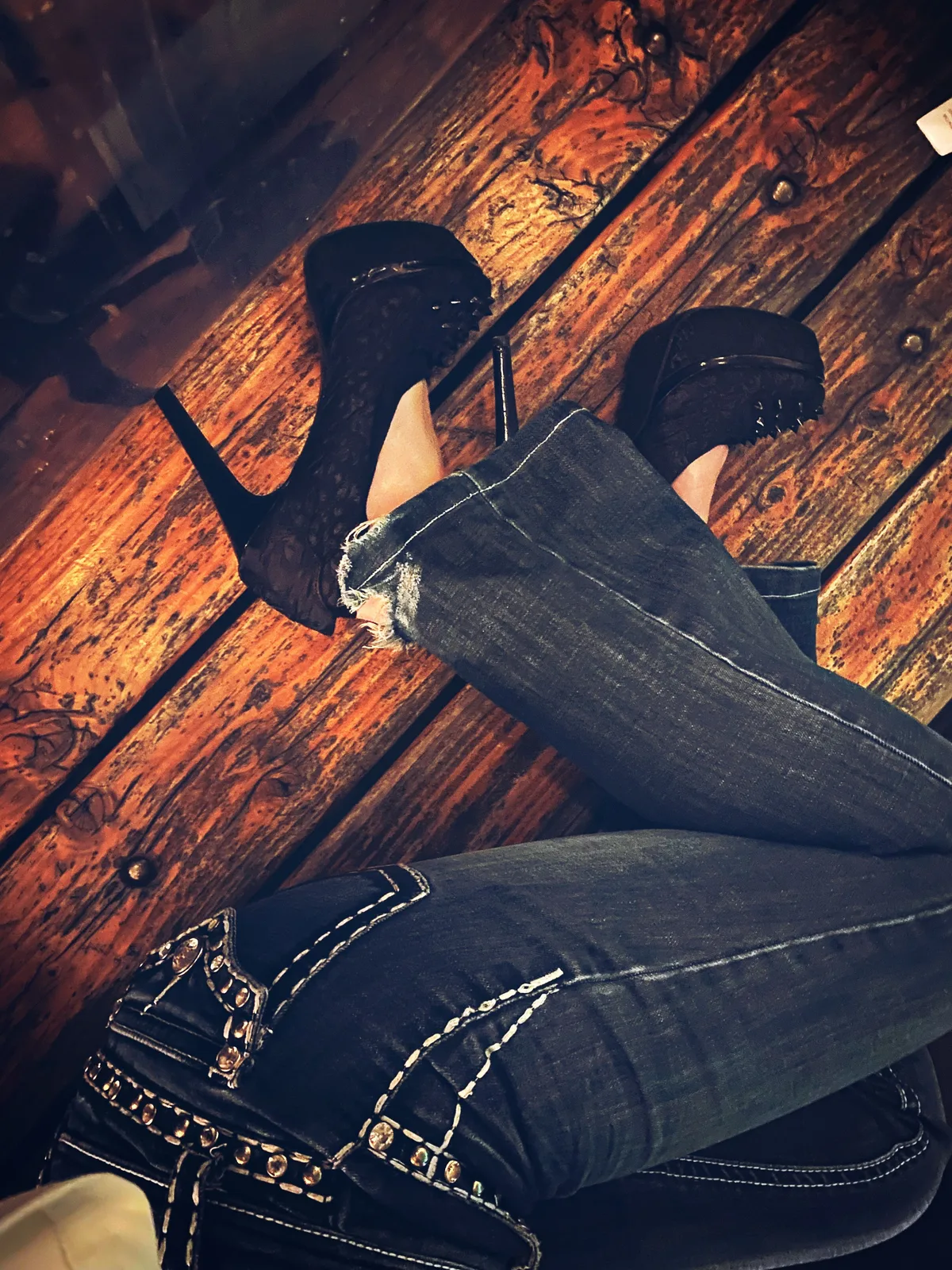 Black platform stilettos with embellished dark denim